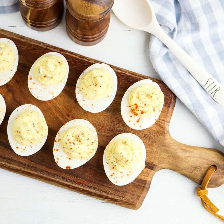 Deviled Eggs on wooden serving board.