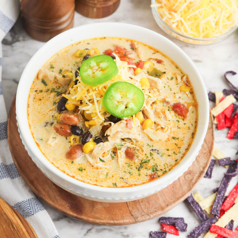 Serving of Creamy Tortilla Soup in white bowl.