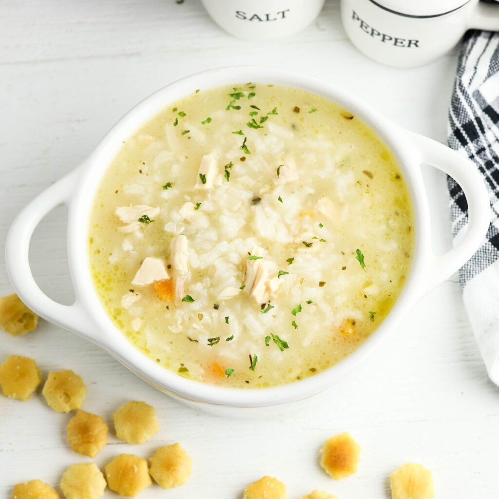 Chicken and Rice soup served in white bowl.