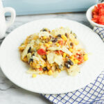A serving of Mexican Chicken Casserole on a white plate.