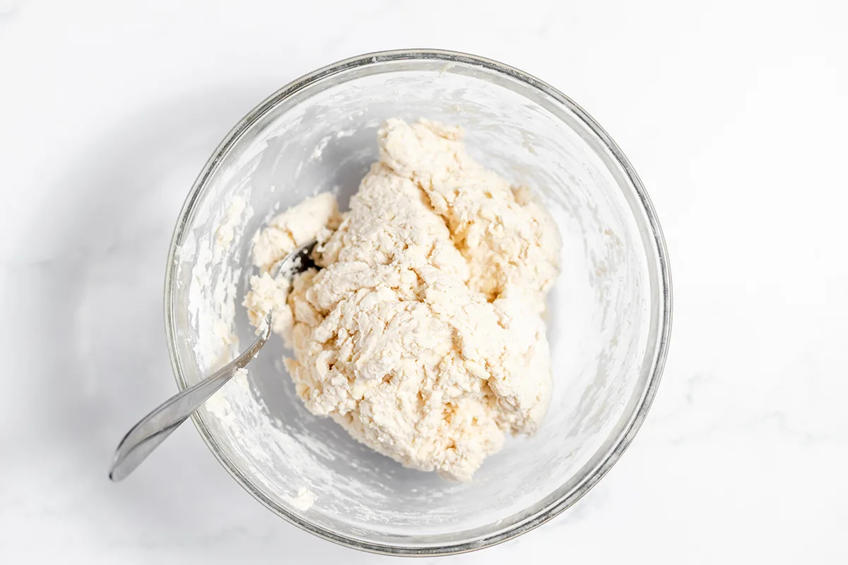 Biscuit dough in glass mixing bowl.