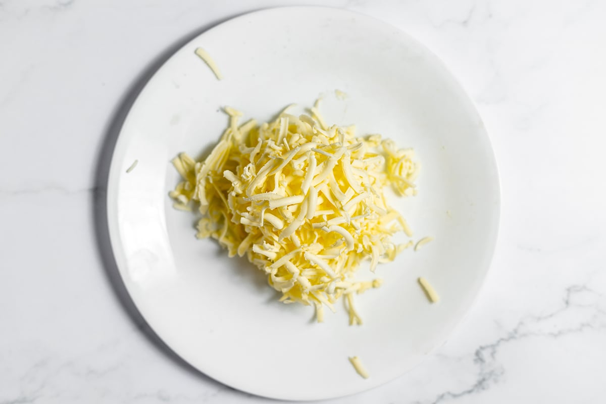 Grated Butter on white plate.
