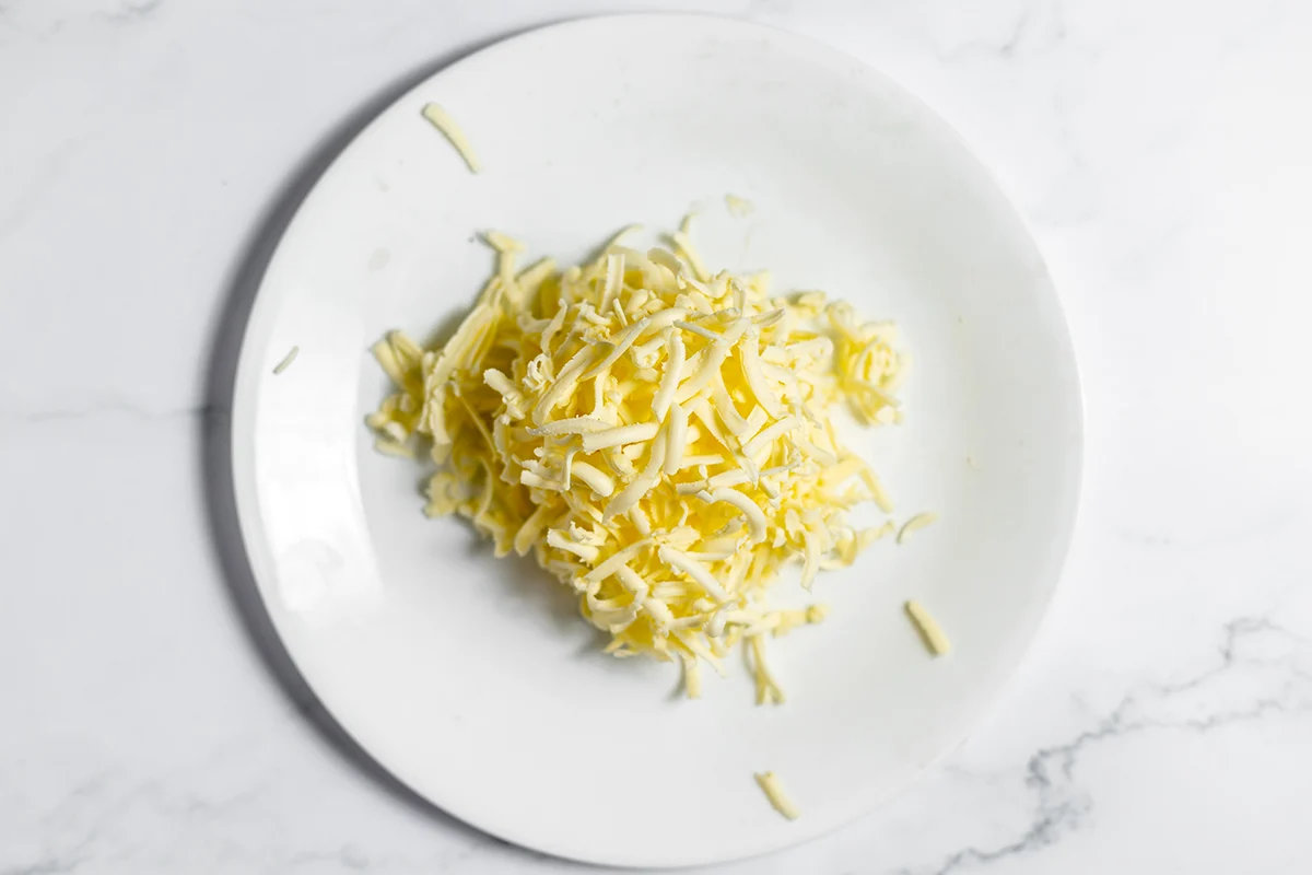 Grated Butter on white plate.