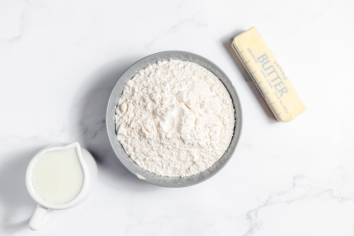 Ingredients for buttermilk biscuits set out on counter.