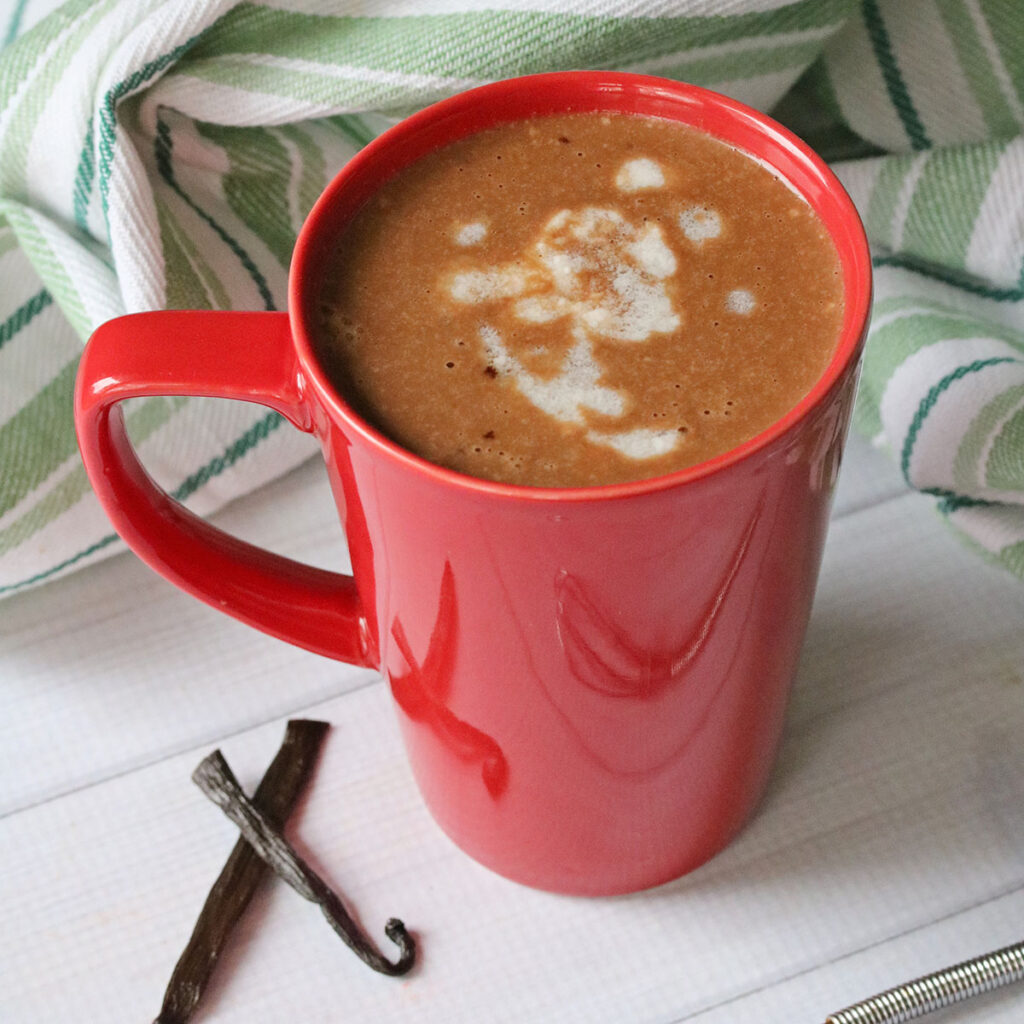 Peppermint Hot Chocolate in red mug on white counter.