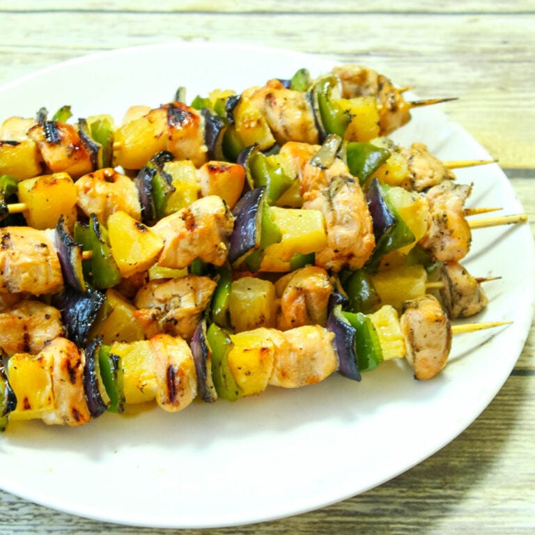 Grilled Hawaiian Chicken Kabobs on white serving platter.