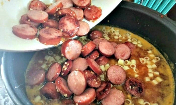 Sausage Bean And Pasta Soup Ingredients Added To Slow Cooker