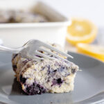Blueberry Lemon Breakfast Cake on plate with fork cutting a piece