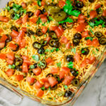 Mexican Layer Dip in glass baking dish on counter