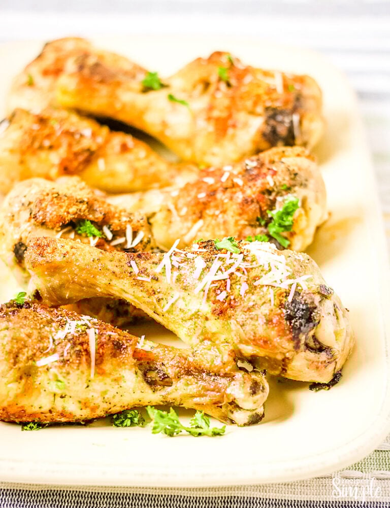 Parmesan Chicken Legs on white platter serving dish