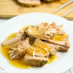 Pork Tenderloin with Gravy poured over it on white plate