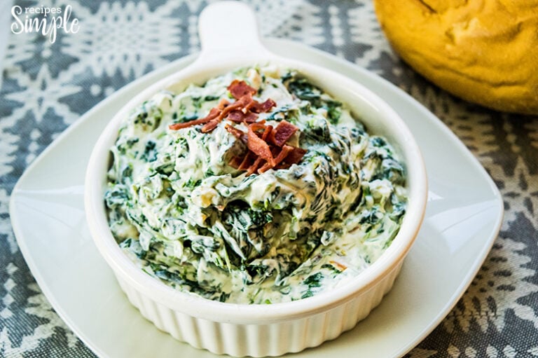 Spinach Dip in white serving bowl on white plate