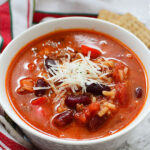 Instant Pot Stuffed Pepper Soup in White Bowl Topped with Cheese