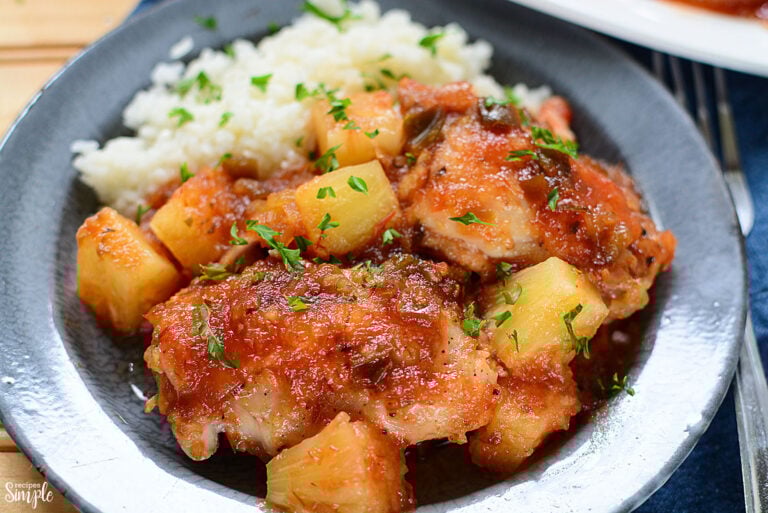 Pineapple Salsa Chicken on blue plate with side of rice