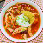 Chicken Taco Soup in bowl topped with sour cream and green onions