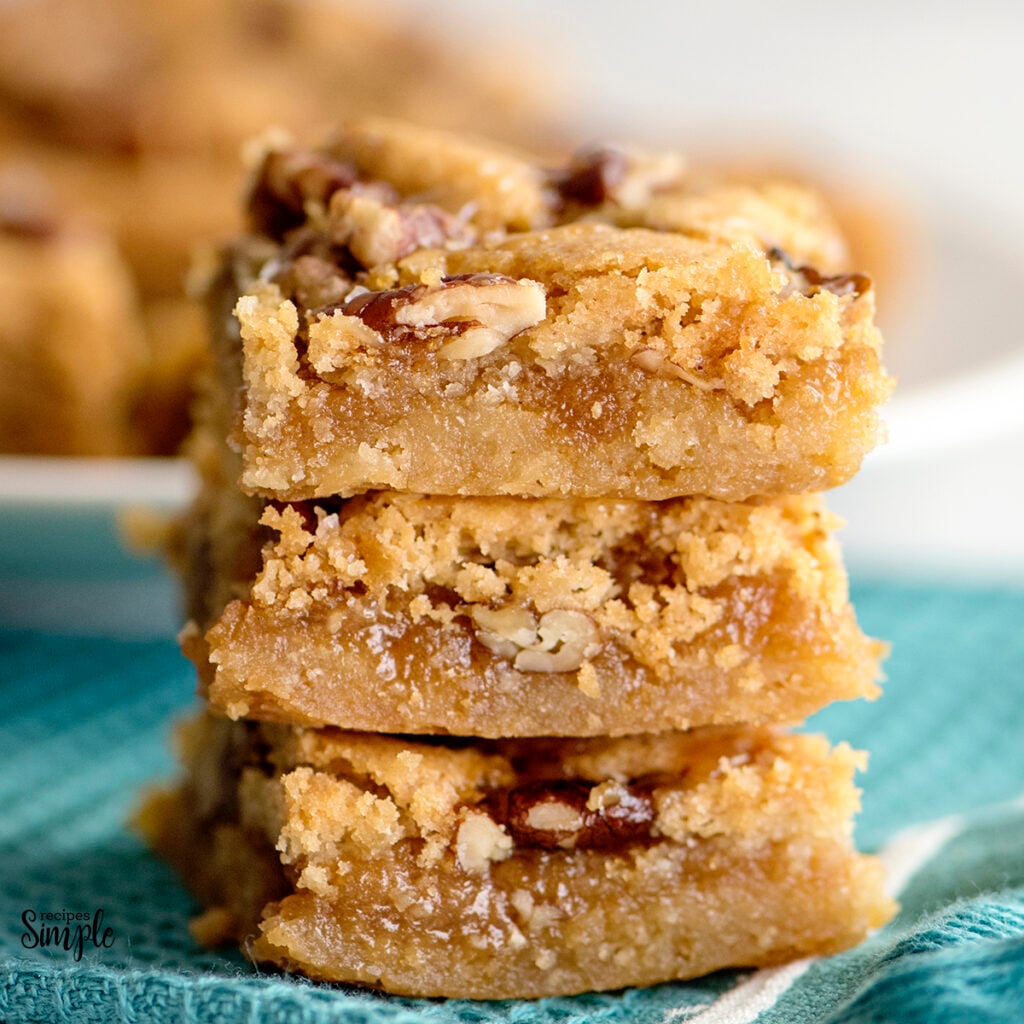 Three Salted Caramel Pecan Bars stack on top of each other
