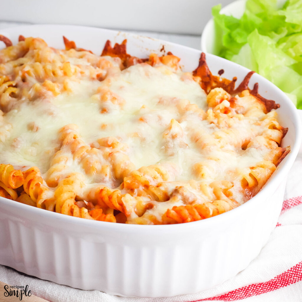 Pizza Pasta in white baking dish topped with cheese