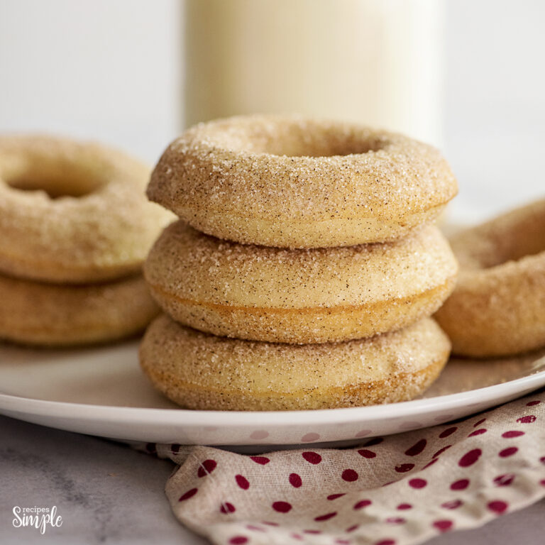 Three Cinnamon Sugar Donuts Stacked on a white plate