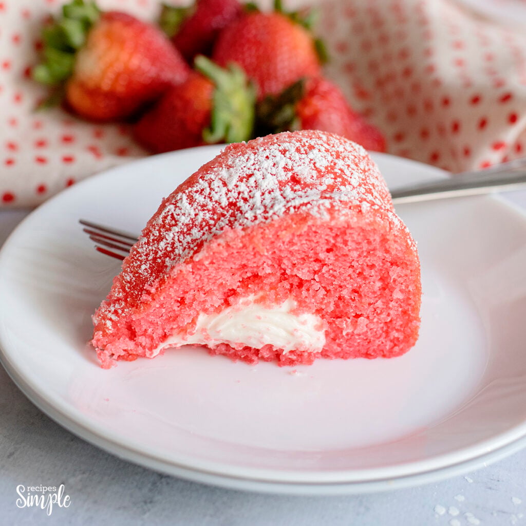 Slice of Strawberry Bundt Cake on white plate