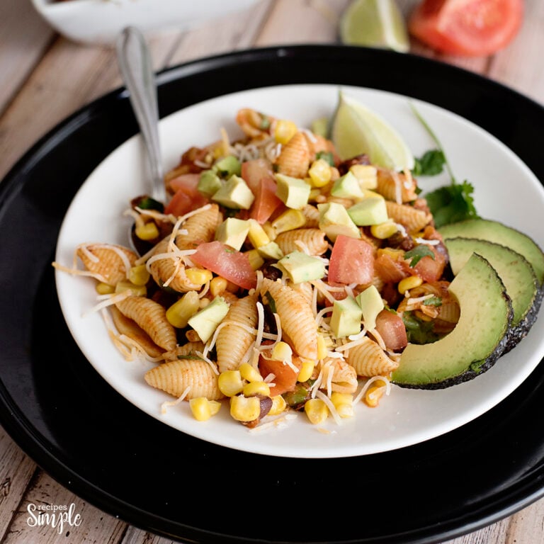 Tex-Mex Pasta Salad on white plate with avocado slices
