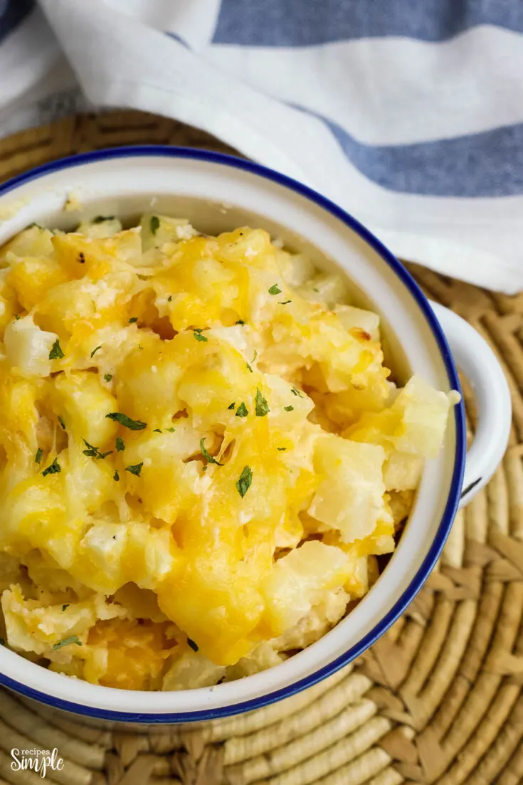Cheesy Potatoes in white serving bowl