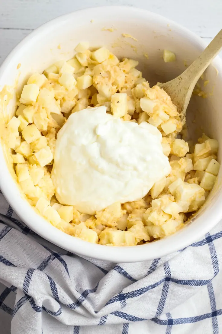 Sour Cream Added to Potatoes in bowl
