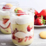 Two Strawberry Cheesecake Pudding Dessert In Mason Jars