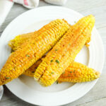 4 Cajun Corn On The Cobs on white plate