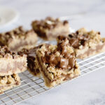 Chocolate Peanut Butter Oatmeal Bars placed on wire rack on white counter.