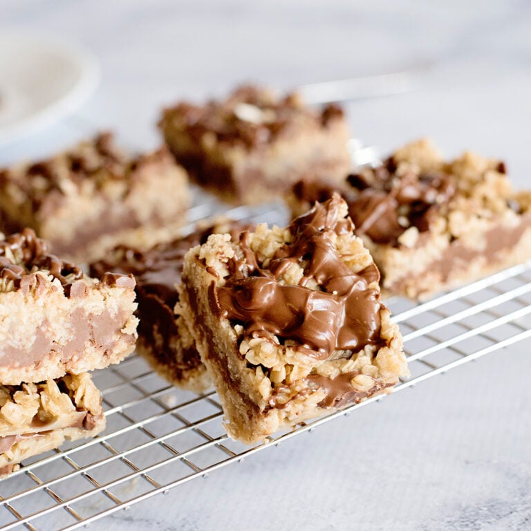 Chocolate Peanut Butter Oatmeal Bars placed on wire rack on white counter.