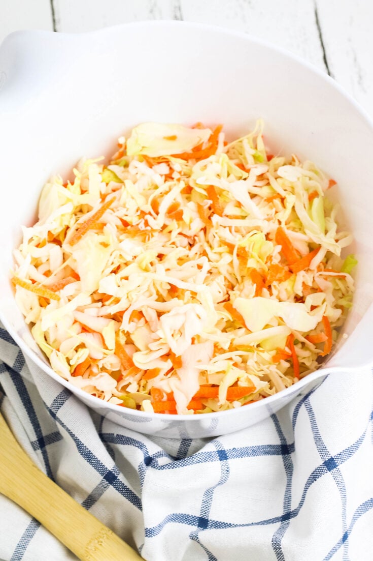 Coleslaw mix added to bowl