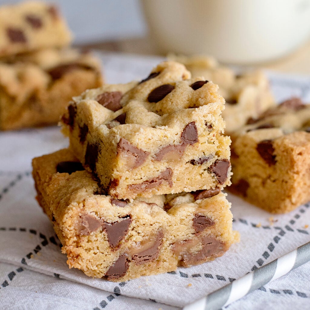 2 Rolo Chocolate Chip Cookie Bars stacked on top of each other on kitchen towel