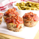 Bacon Cheeseburger Meatloaf Muffins on wooden serving board.