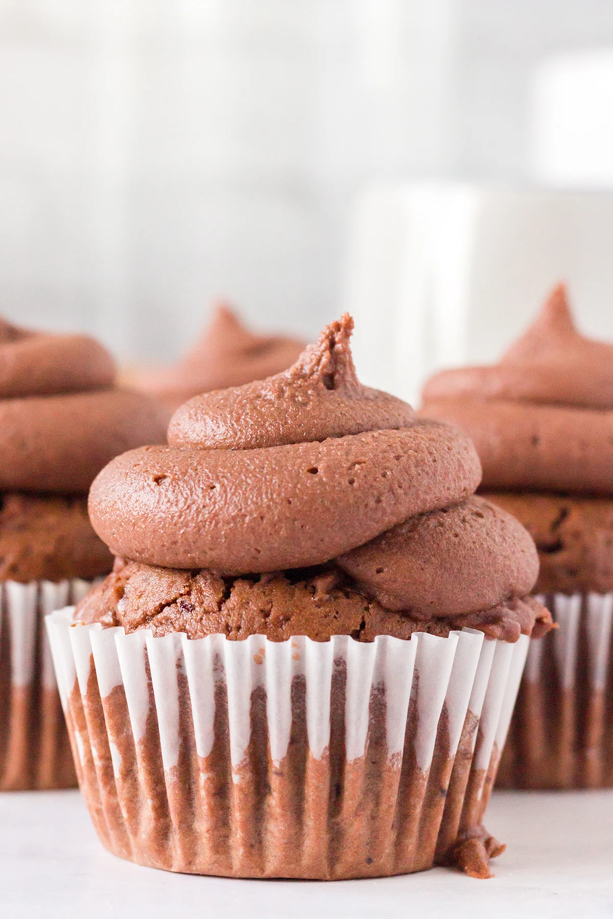 Chocolate Frosted Mocha Cupcakes on kitchen counter.