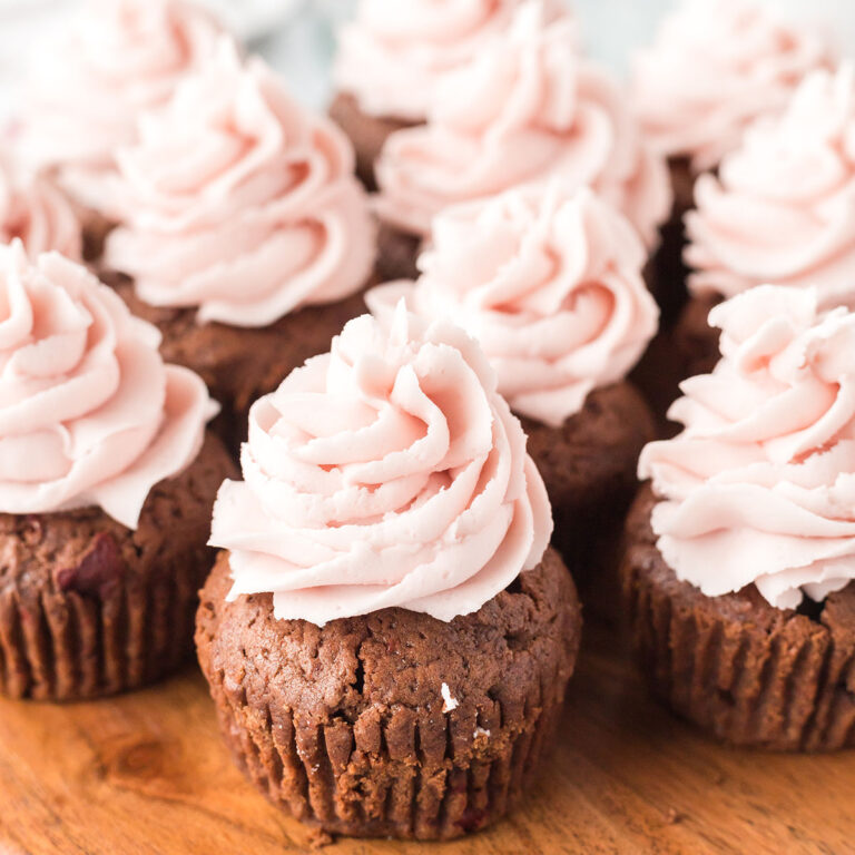 Chocolate Cherry Cupcakes on wooden serving board.