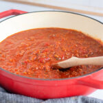 Spaghetti Meat Sauce in large red saucepan ready to serve over pasta.