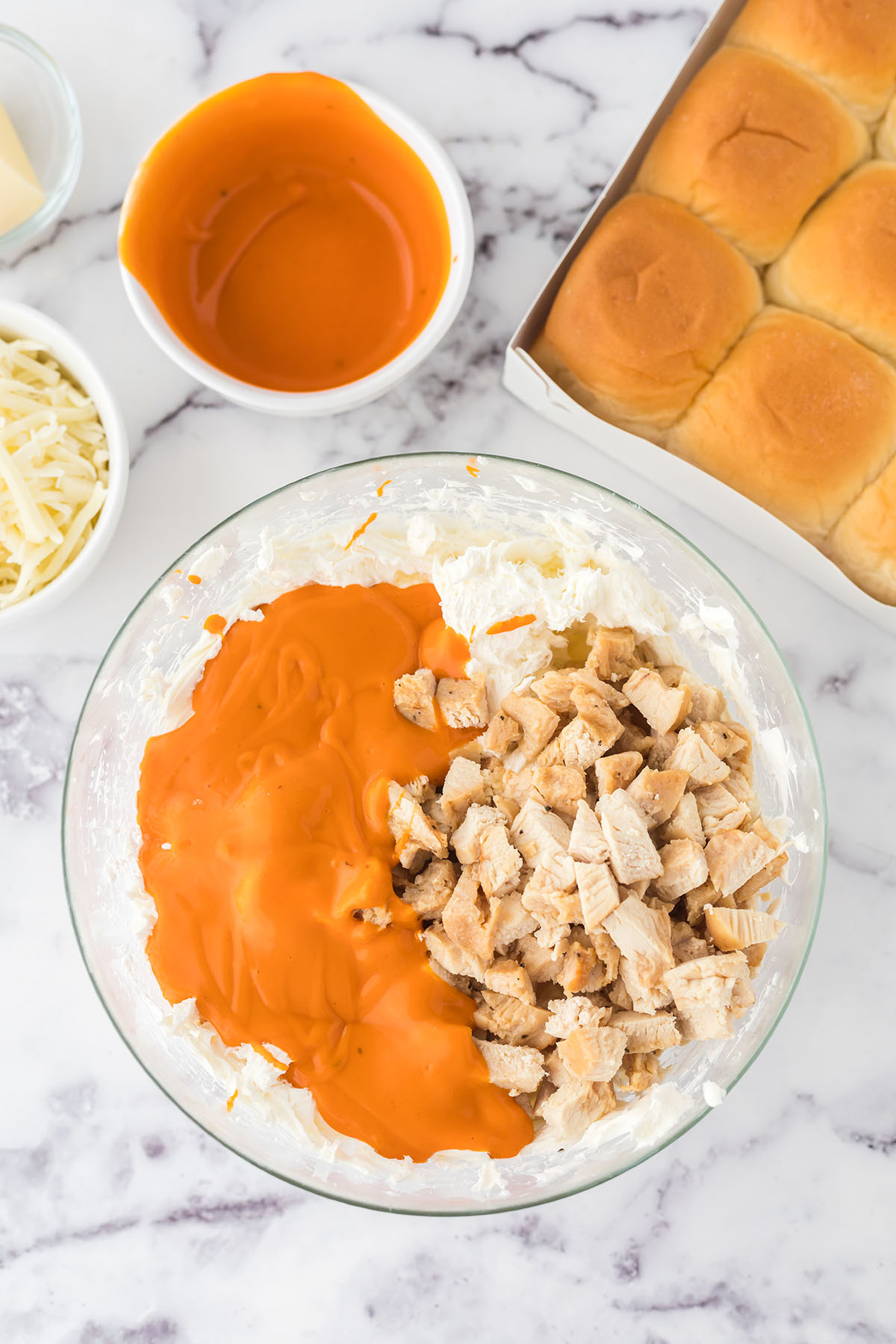 Buffalo chicken Ingredients in glass mixing bowl.