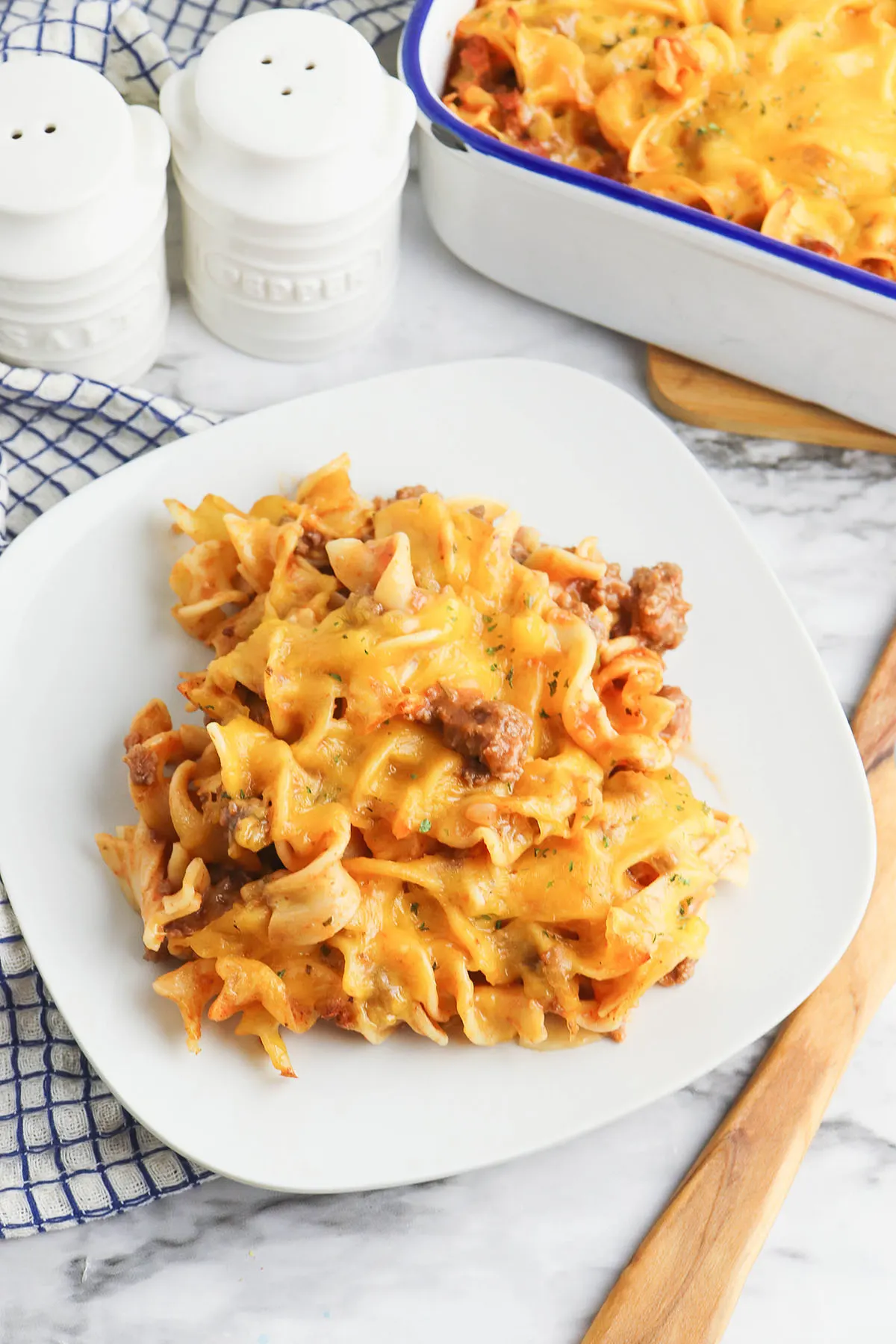 Serving of Beef Noodle Casserole on square white plate.