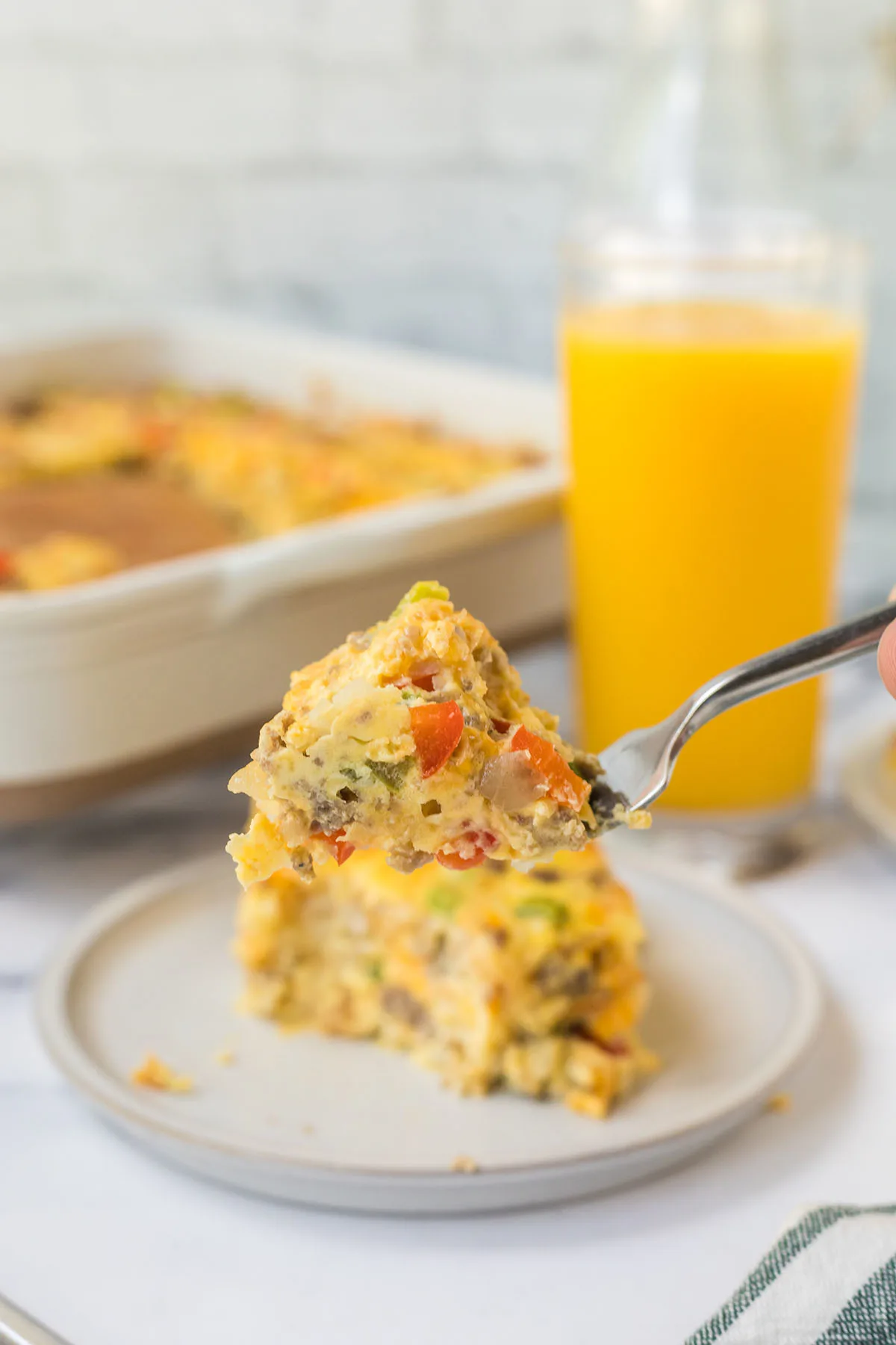 A bite of the breakfast casserole on a fork.