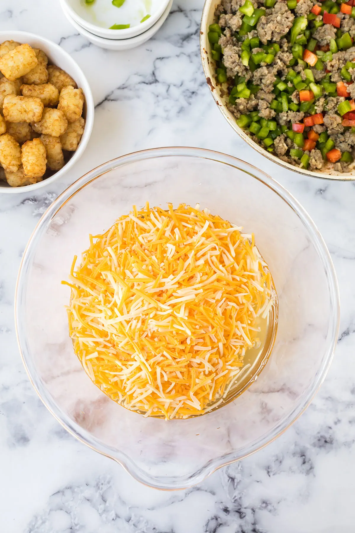 Eggs, Colby jack cheese and sour cream in mixing bowl.