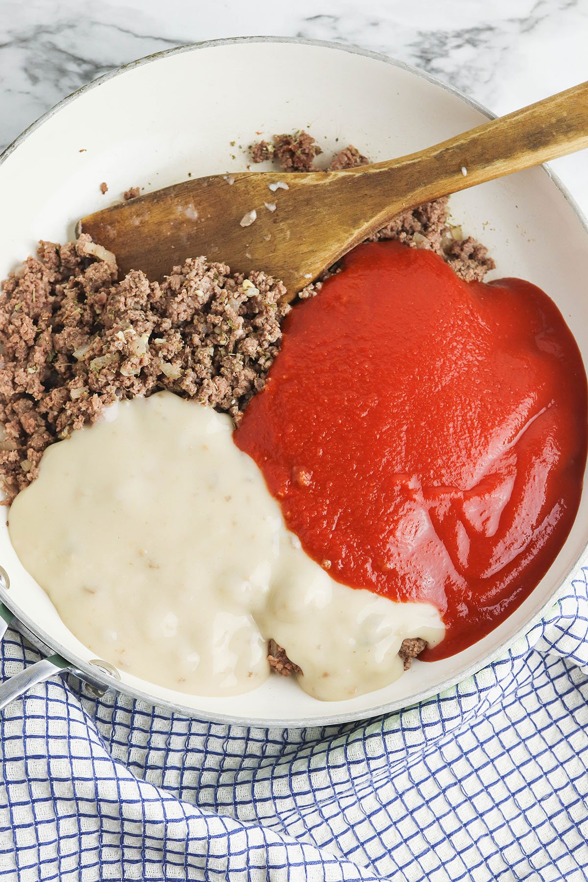 Ground Beef tomato sauce and cream of mushroom soup in bowl.