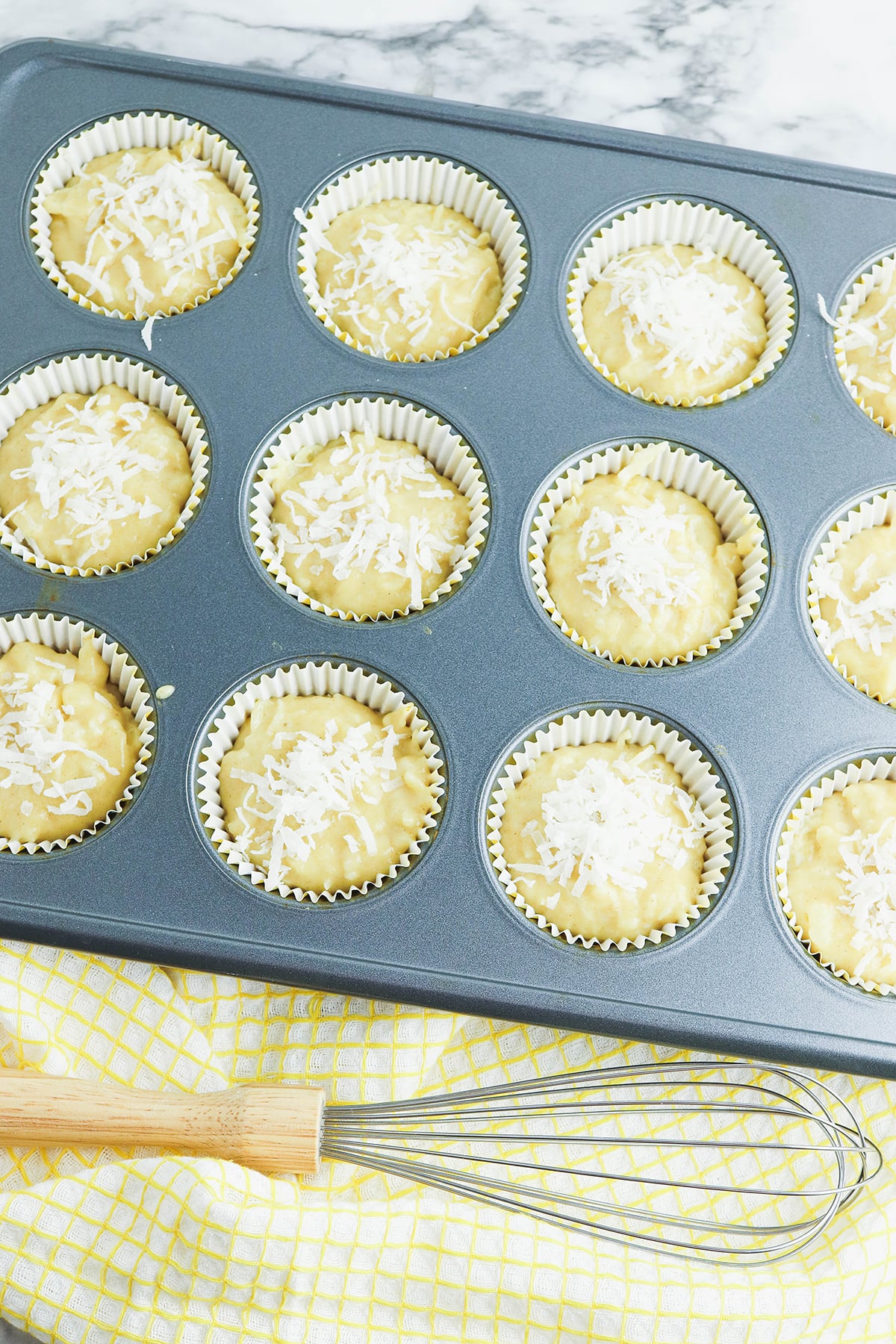 Muffin batter added to baking pan.
