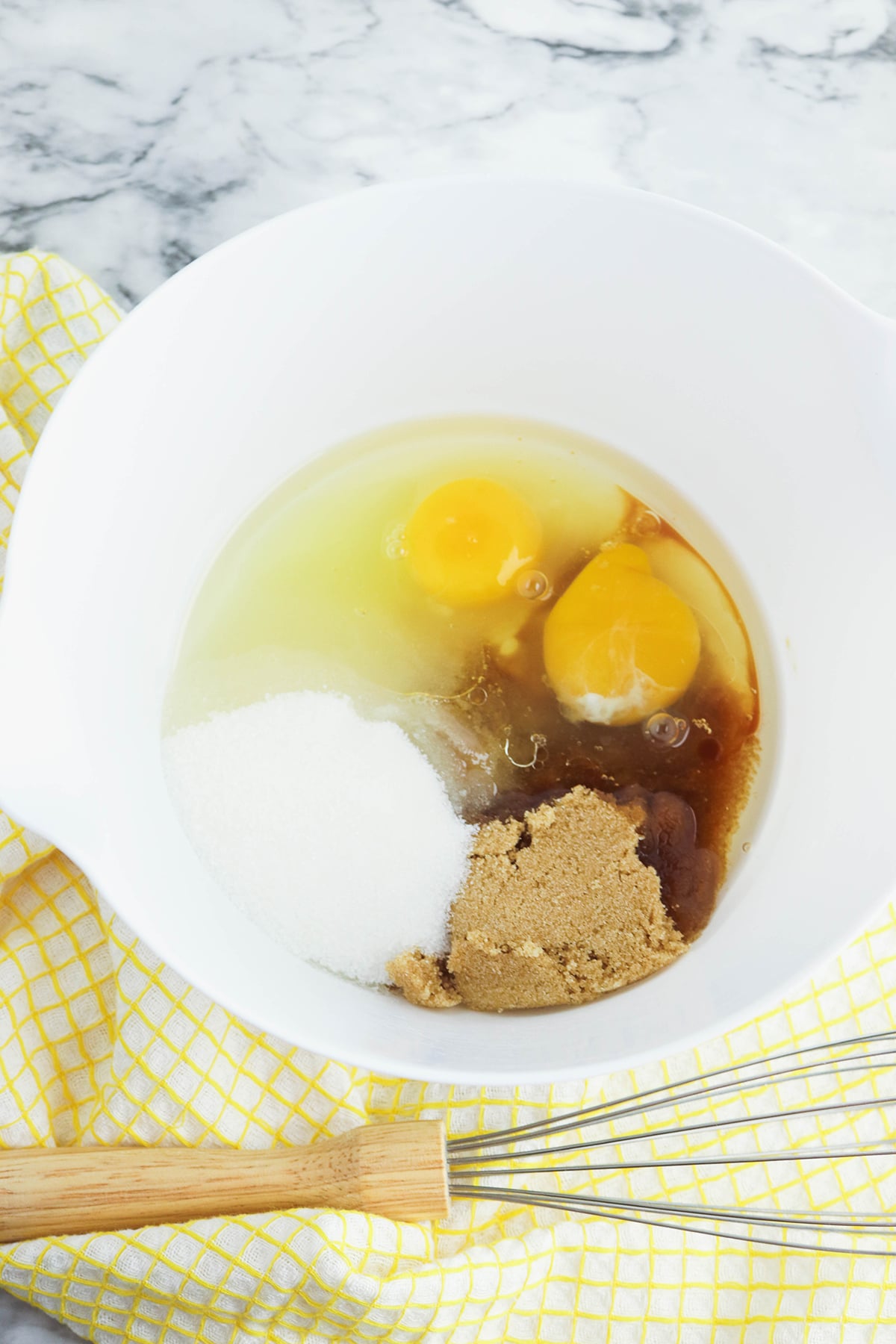 Vegetable oil, brown sugar, eggs and vanilla extract in mixing bowl.