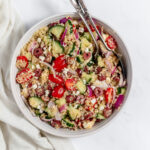Greek Quinoa Salad in large white serving bowl.