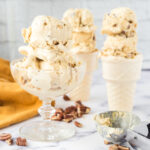 2 scoops of Pecan Pie Ice Cream in glass dish and 2 scoops in 2 ice cream cones.