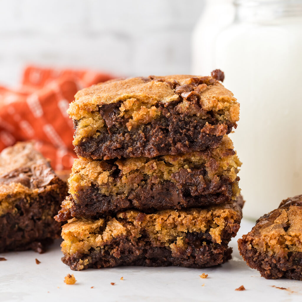 Three Brookie Bars stacked on top of each other on counter.
