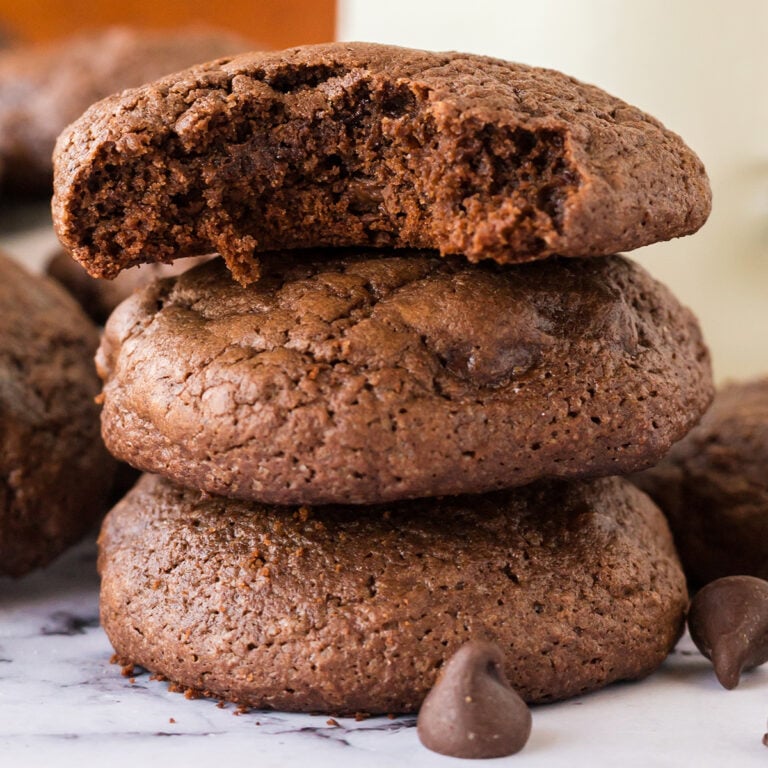 Three Brownie Cookies stacked on counter.
