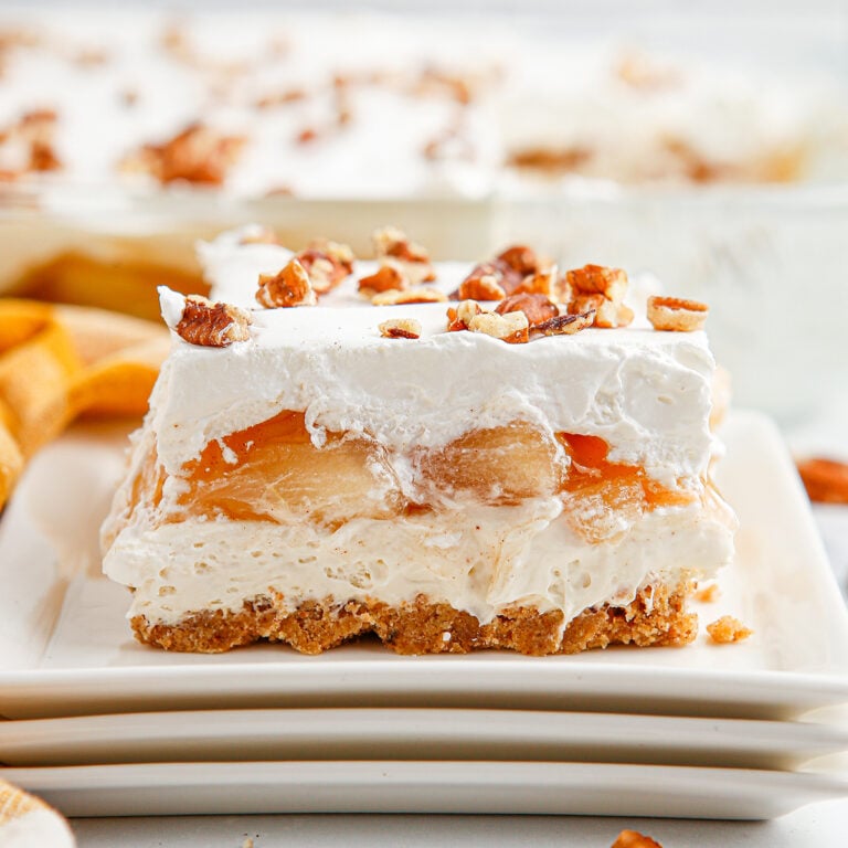 Slice of Apple Delight on white plate.