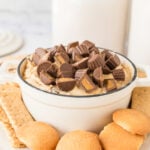 Peanut Butter Dip in white serving bowl with vanilla wafers and graham crackers for dipping.