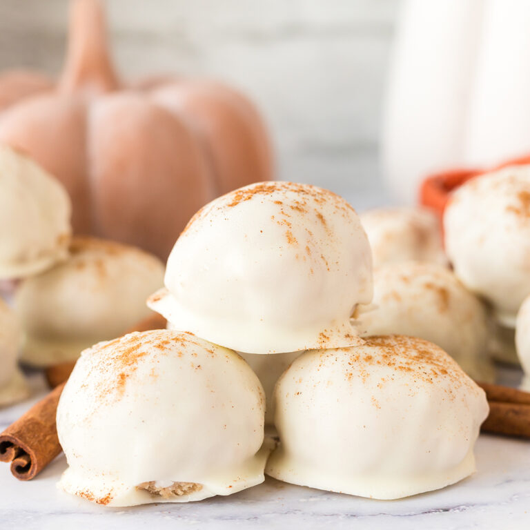 Three Pumpkin Spice Truffles stacked together on counter.